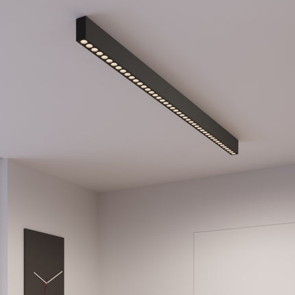 Plafonnier Design Poutre noir éclairant un espace de vie design