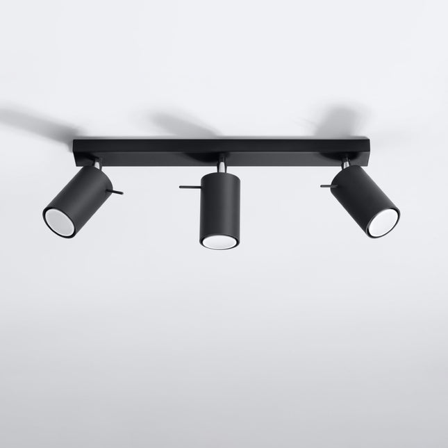 Plafonnier directionnel 3 spots LED noir éclairant un salon