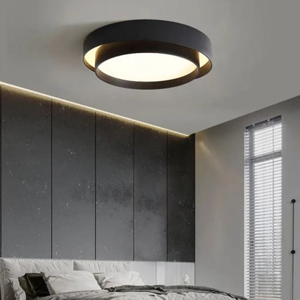 Plafonnier LED double cercle noir dans une chambre contemporaine