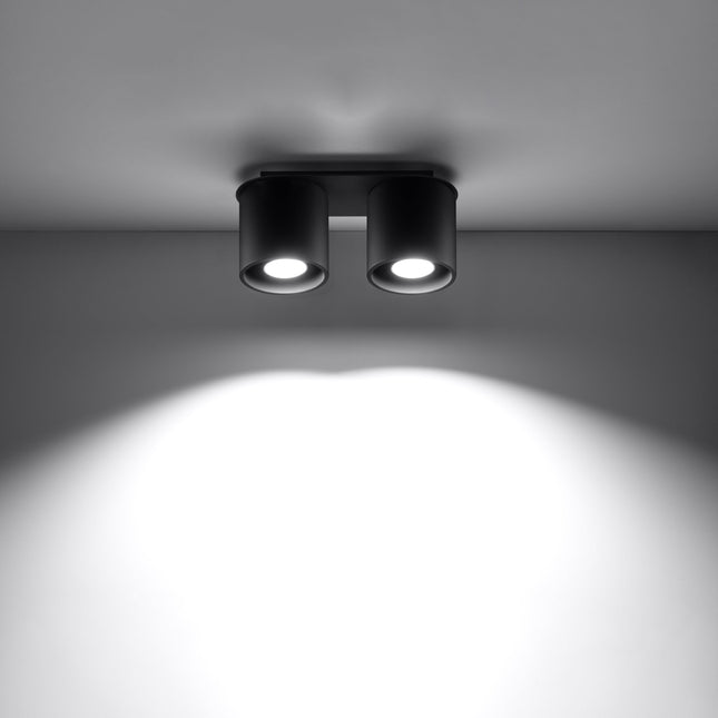 Plafonnier double cylindre LED noir éclairant une entrée