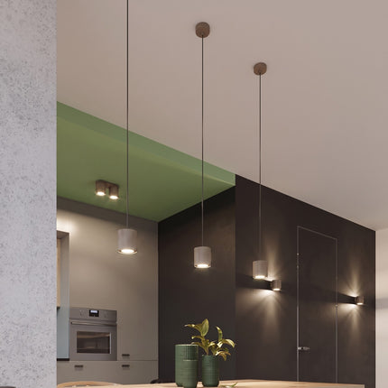 Plafonnier Double Cylindre LED taupe au-dessus d'un plan de travail