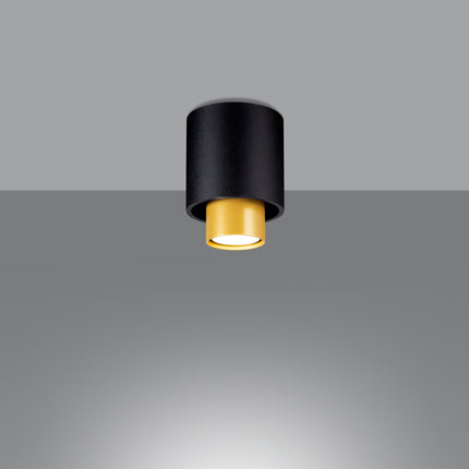 Plafonnier double cylindre en acier noir mat avec cylindre intérieur en laiton, vue de face sur fond gris