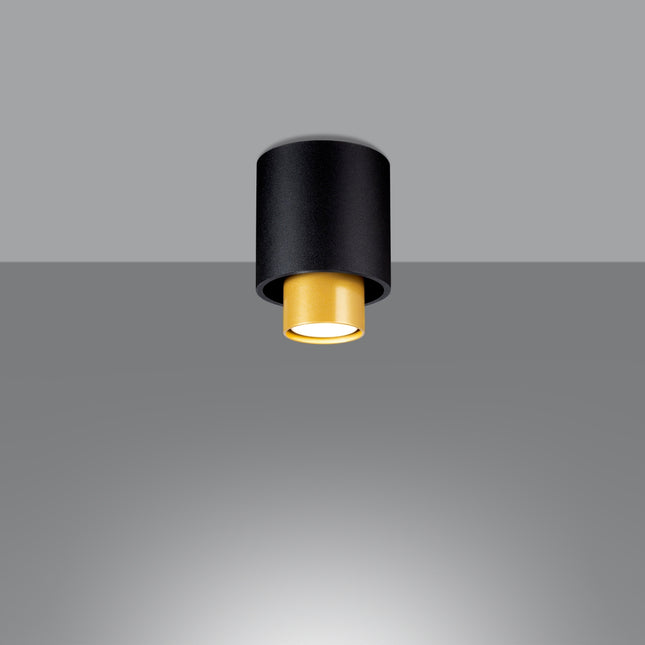 Plafonnier double cylindre en acier noir mat avec cylindre intérieur en laiton, vue de face sur fond gris
