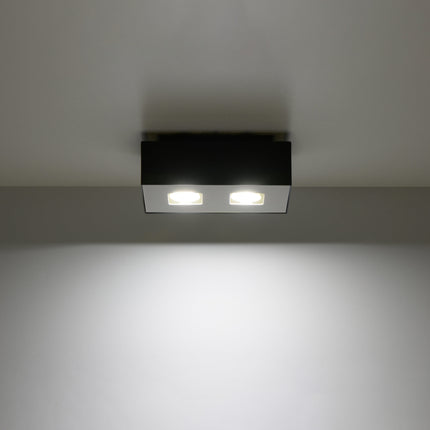 Plafonnier Double Raffiné noir projetant un faisceau de lumière vers le bas