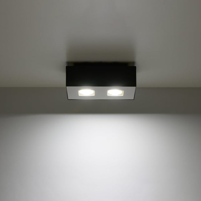 Plafonnier Double Raffiné noir projetant un faisceau de lumière vers le bas