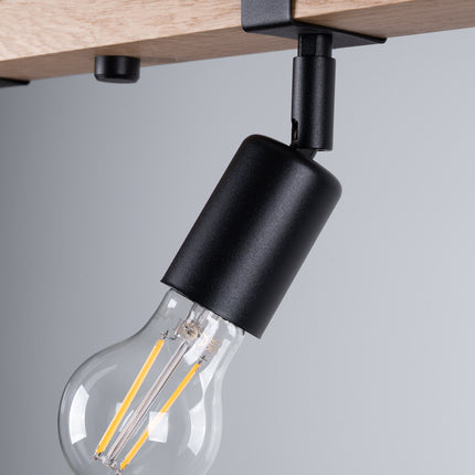 Détail du mécanisme orientable d'un spot du plafonnier Élégance Bois Noir, articulation en métal noir sur bois