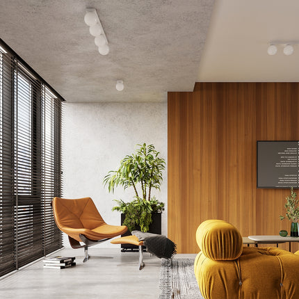Plafonnier Globe Solis blanc installé au plafond d'un salon lumineux au style contemporain