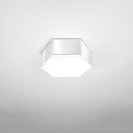 Plafonnier Hexagonal Pure 11 blanc allumé, lumière chaude diffusée par le hublot blanc.