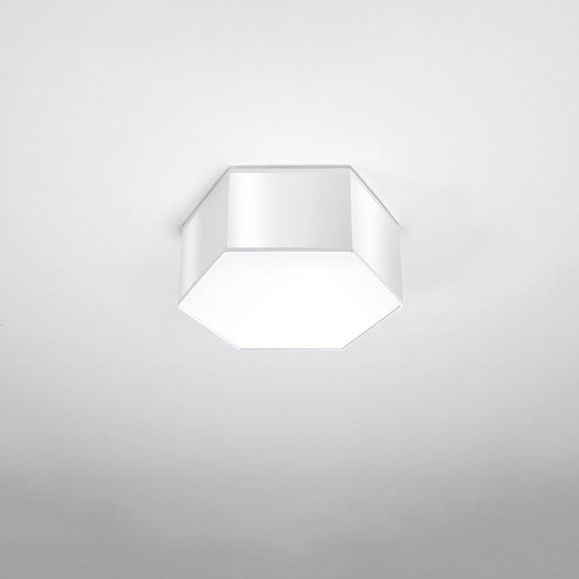 Plafonnier Hexagonal Pure 13 blanc allumé, lumière chaude diffusée par le hublot blanc.