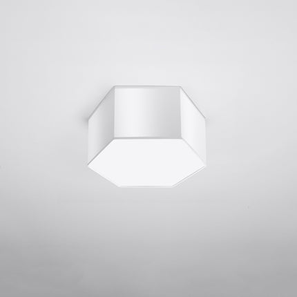 Plafonnier Hexagonal Pure 15 blanc allumé, lumière chaude diffusée par le hublot blanc.