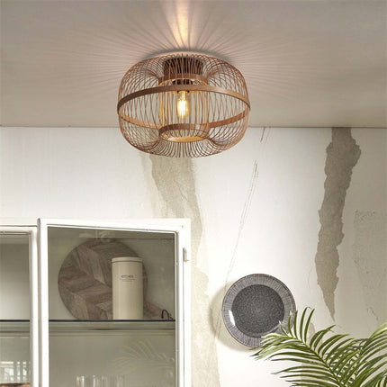 Hokkaido ceiling light in braided natural bamboo hanging on the ceiling near a white dresser