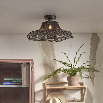 Ibiza Wavy ceiling light bamboo black installed in a Japandi interior, with dimension of a bookcase and of a green plant