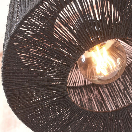 Close-up of the handcrafted black jute weave of the Iguazu ceiling light with lit filament bulb