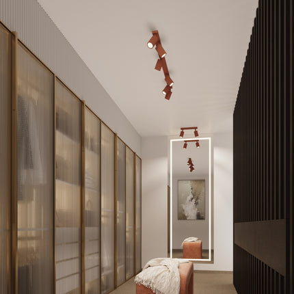Plafonnier Oslo barre 2 spots orientables 30 cm rouge ocre, au-dessus d'un plan de travail