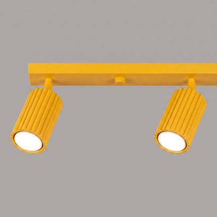 Plafonnier Oslo Barre 4 Spots Orientables 81 cm en Aluminium Jaune Ambré, vue sur fond coloré