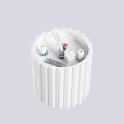 Close-up view of the Aura spot ceiling light, matt white finish and vertical grooves