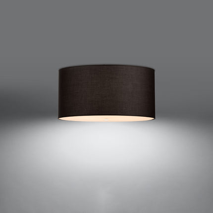 Plafonnier tambour en tissu noir allumé, diffuseur en verre éclairé sur fond gris
