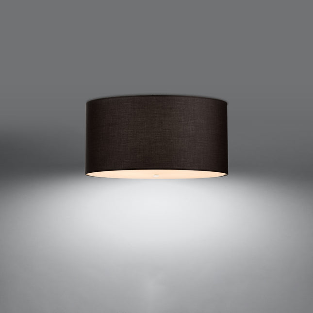 Plafonnier tambour en tissu noir allumé, diffuseur en verre éclairé sur fond gris