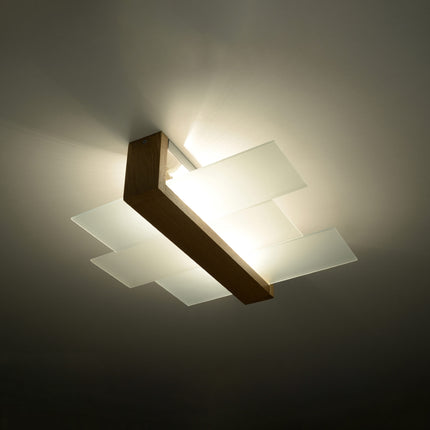 Plafonnier panneaux horizontal bois naturel diffusant une lumière tamisée dans un salon