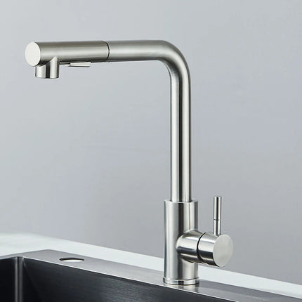 Robinet de cuisine à douchette extractible finition nickel brossé, bec haut en L, au-dessus d'un évier
