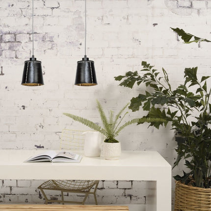 Two black recycled rubber Amazon pendant lights grouped above a console