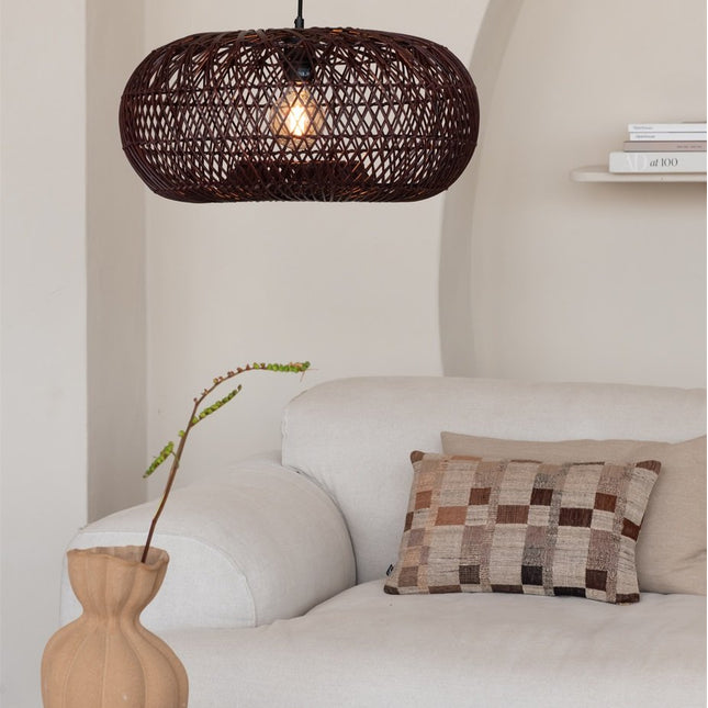 Suspension Arizona en bambou tressé naturel et brun, suspendue au-dessus d'une étagère en bois dans un intérieur chaleureux.