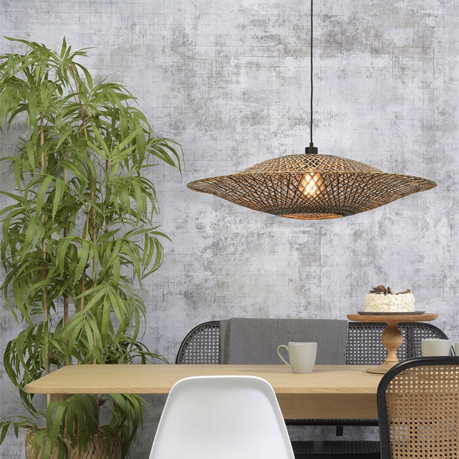 Pendant light Bali in black braided bamboo and natural lit above a dining table in wood