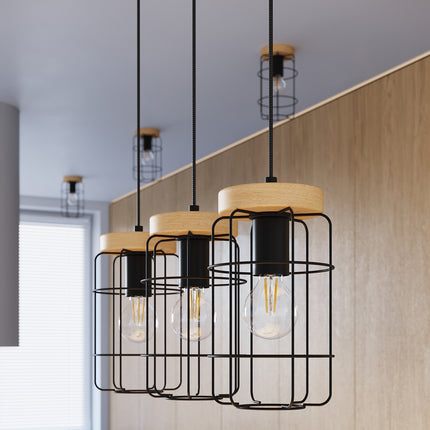 Suspension Cage Industrielle 3 lumières installée au-dessus d'un îlot de cuisine en bois