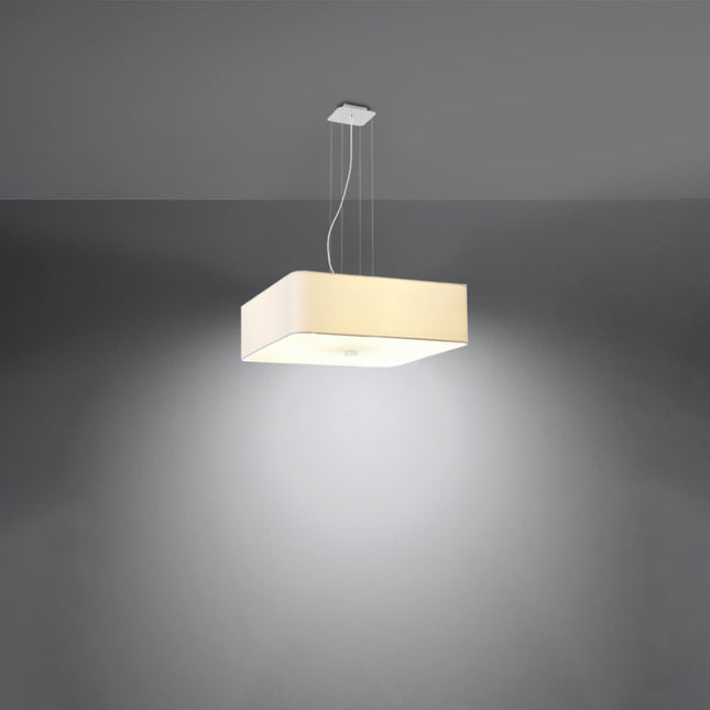 Suspension carrée en tissu blanc allumée diffusant une lumière chaude dans la pièce