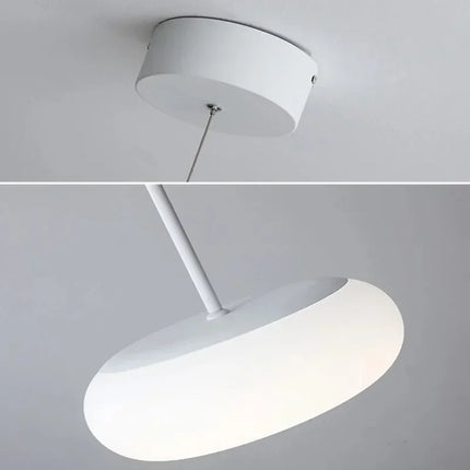 Suspension circulaire acrylique nordique blanche au-dessus d'une table à manger