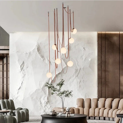 Suspension en cuir cognac à hauteur ajustable, cordon détaché du plafond pour une installation personnalisée.
