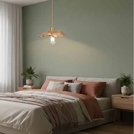 Suspension en verre ambré fleur au-dessus d'un lit dans une chambre aux murs vert sauge