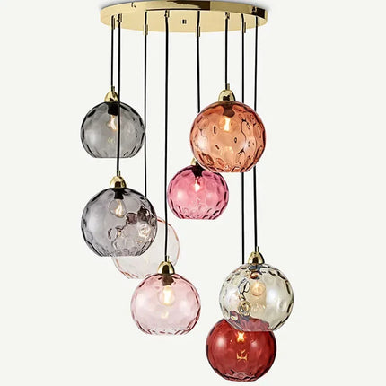 Grappe de globes en verre soufflé aux teintes ambre, rose et gris fumé sur rosace dorée