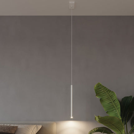 Suspension Halo 1 blanche au-dessus d'un canapé, ambiance salon épurée avec plante verte
