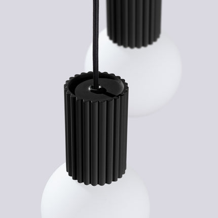 Suspension Halo 2 globes en grappe noire sur fond coloré, vue de trois quarts