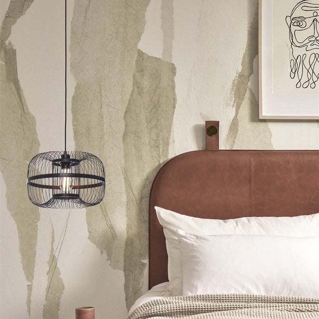 Pendant light Hokkaido in bamboo and black iron above a bedside, in a bedroom with a mineral decor