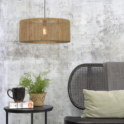 Pendant light Iguazu in natural braided jute hanging above a coffee table in a bohemian living room