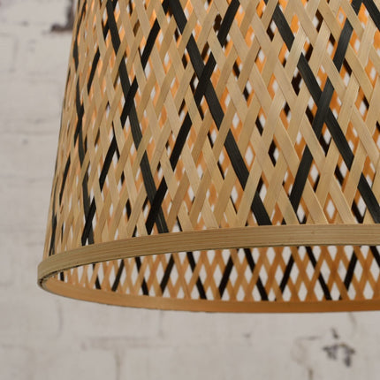 Close-up view of the braided bamboo bottom edge of the conical lampshade of the Kalimantan pendant light