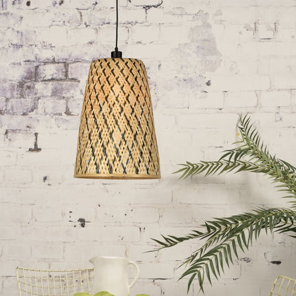 Pendant light Kalimantan in natural conical braided bamboo and black hanging in front of a wall of bricks painted