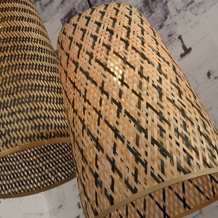 Tilted view of the natural and black bamboo weave of the conical lampshade of the Kalimantan pendant light on