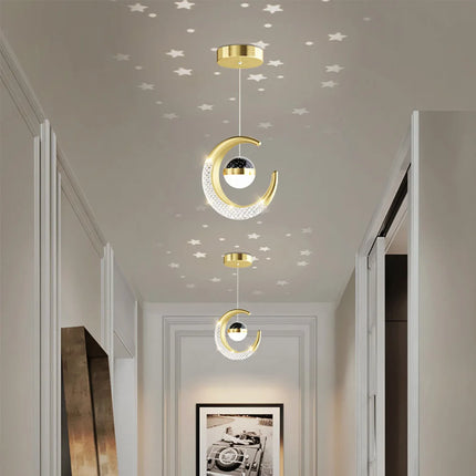 Deux suspensions lune LED dorées installées au plafond d'un couloir lumineux