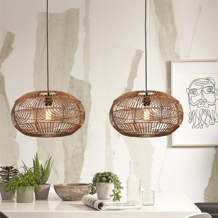 Two woven rattan Madeira pendant lights side by side above a table, warm soft light