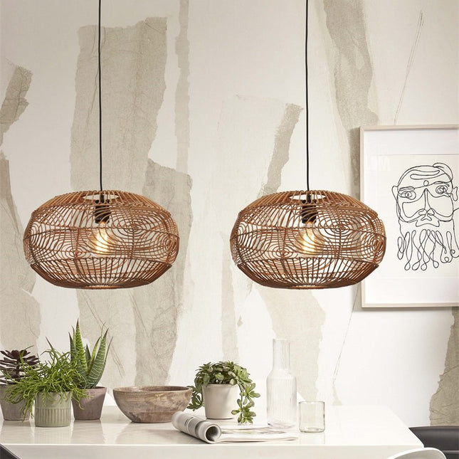 Two woven rattan Madeira pendant lights side by side above a table, warm soft light