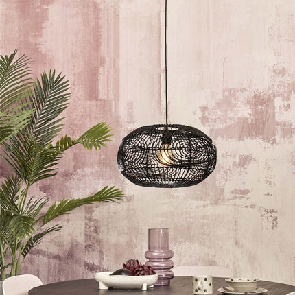 Pendant light Madeira in black braided rattan hanging above a table, atmosphere dining room cozy