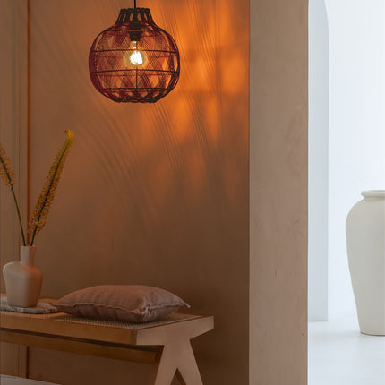 Suspension Mendoza allumée projetant des jeux d'ombres sur un mur terracotta près d'une entrée voûtée