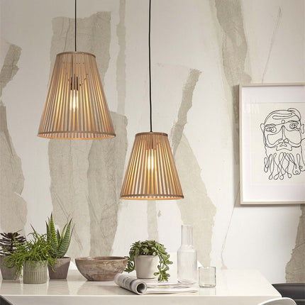 Pendant light Merapi in braided natural bamboo, shape conical flared, above a table in a bright living room
