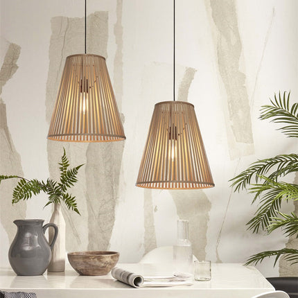 Two natural bamboo Merapi pendant lights lit, striped light effect in an interior full of plants