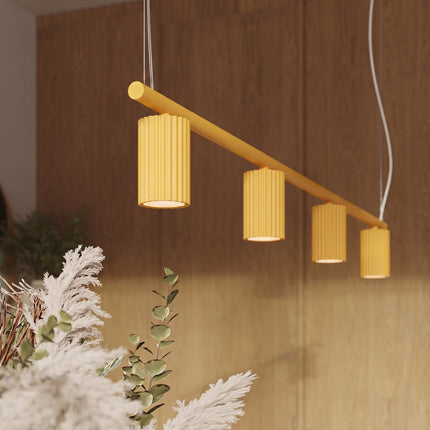 Suspension Oslo poutre 4 cylindres 122 cm jaune ambré dans un intérieur contemporain