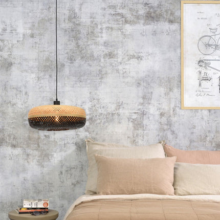 Pendant light Palawan in braided bamboo hanging above a bed in a cozy bedroom