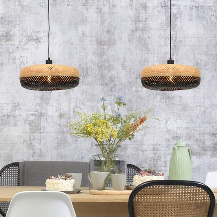 Two woven bamboo Palawan pendant lights installed side by side above a table
